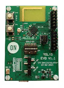 Green circuit board with numerous electronic components, including switches, LEDs, and connectors, displaying the RSL15 EVD V1.1 description..