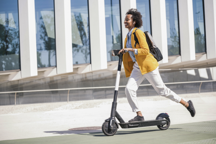 0325-image-of-a-woman-with-a-backpack-riding-a-scooter.