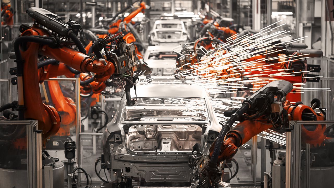 Robotic arms in action on an automtive assembly line