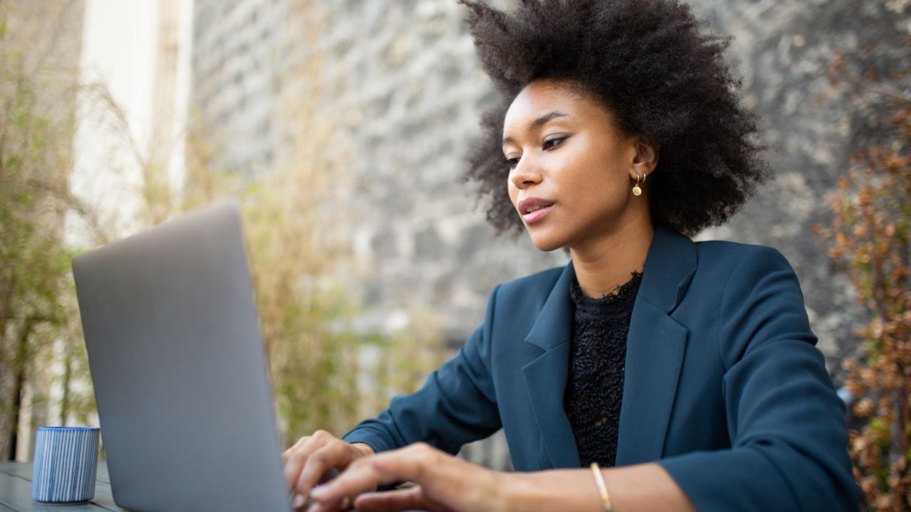 Businesswoman sitting with laptop computer at table