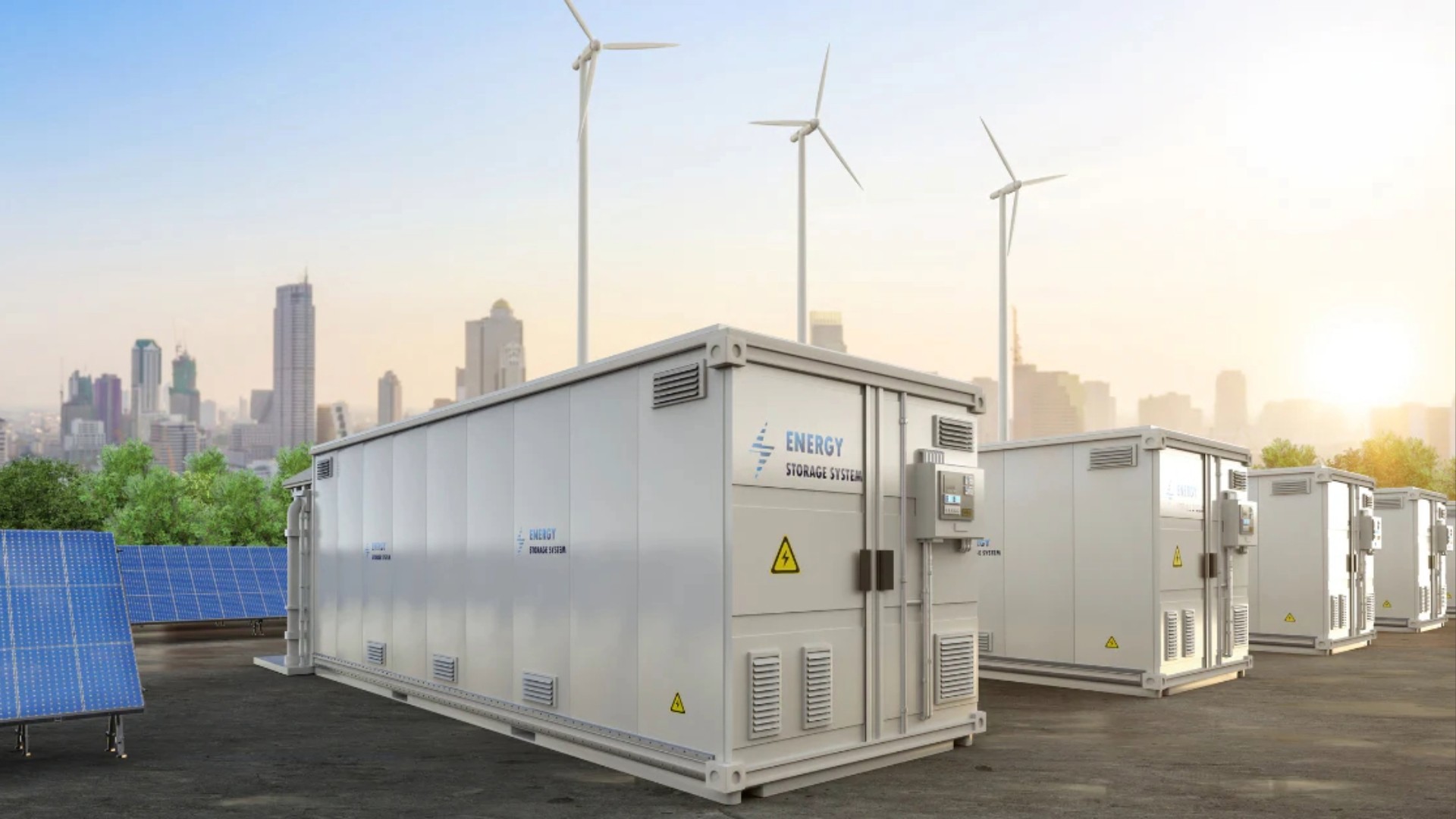 Large white energy storage containers are installed outdoors near a modern city skyline.