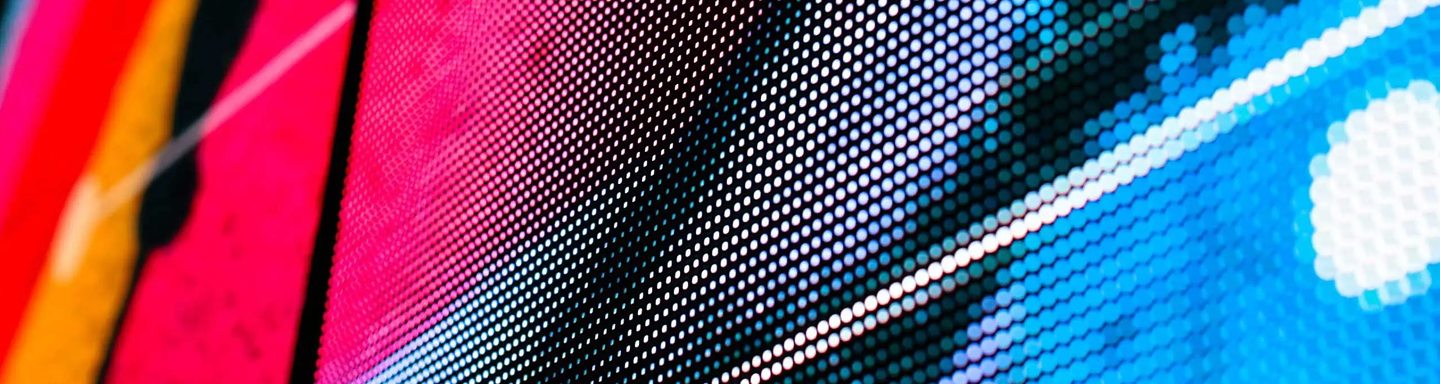 A detailed macro view of an LED screen showcasing vibrant pixel patterns