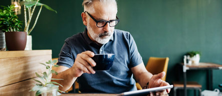 Man_Reading_Tablet_at_Cafe