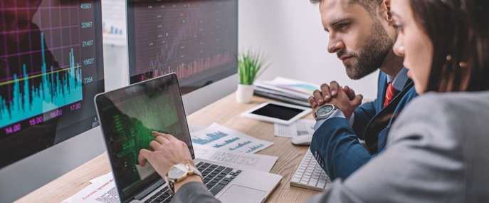 Side view of computer systems analysts using chart