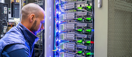 A Specialist Connects The Wires In A Server Room