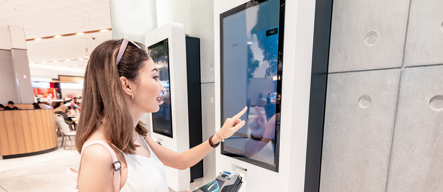 Asian_Woman_Using_Touchscreen_Kiosk
